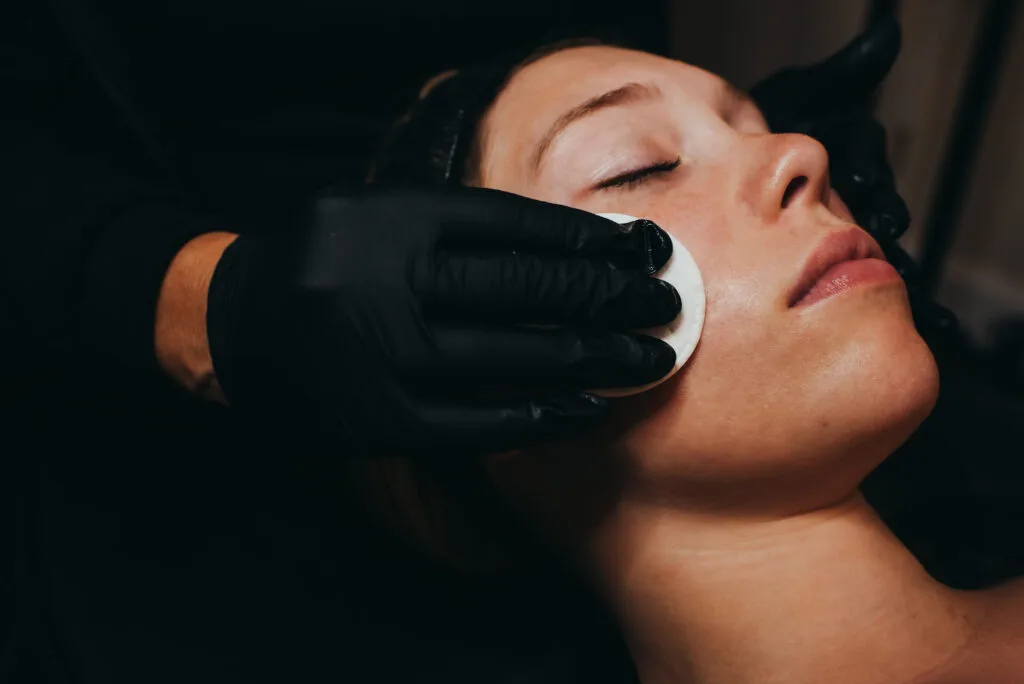 Young beautiful girl during cosmetic procedures in the beautician's office. Spa, beauty, wellness, antiaging procedure, cosmetics | Uptown Aesthetics and Wellness in Martinsville, VA