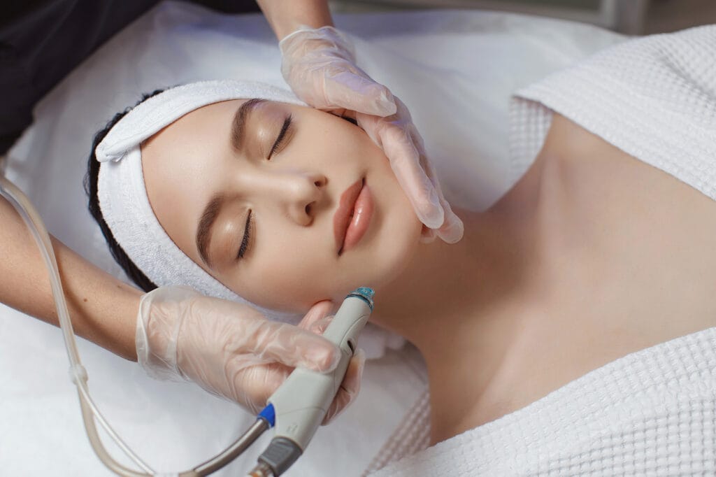 Close up of a lovely caucasian woman having microdermabrasion non invasive therapy with derma pen in a Medical Spa | Uptown Aesthetics and Wellness in Martinsville, VA