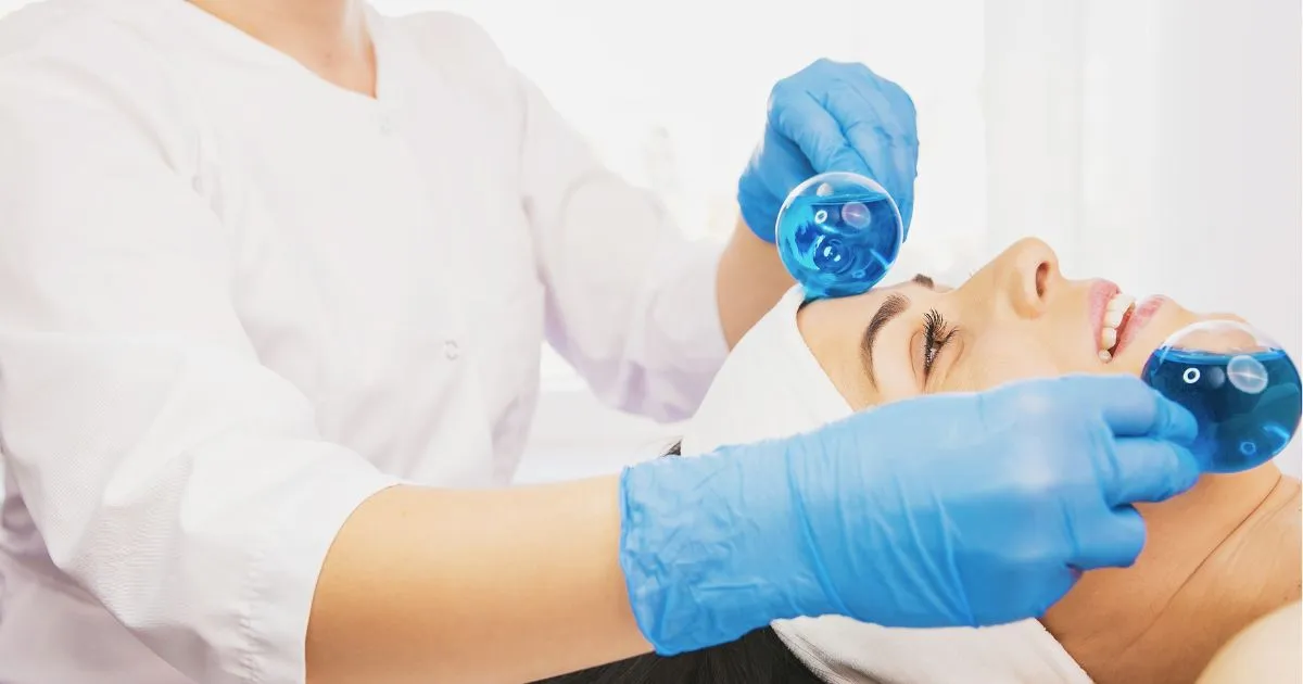Esthetician performing a Fire & Ice Facial in Wilmington, NC, using cooling globes
